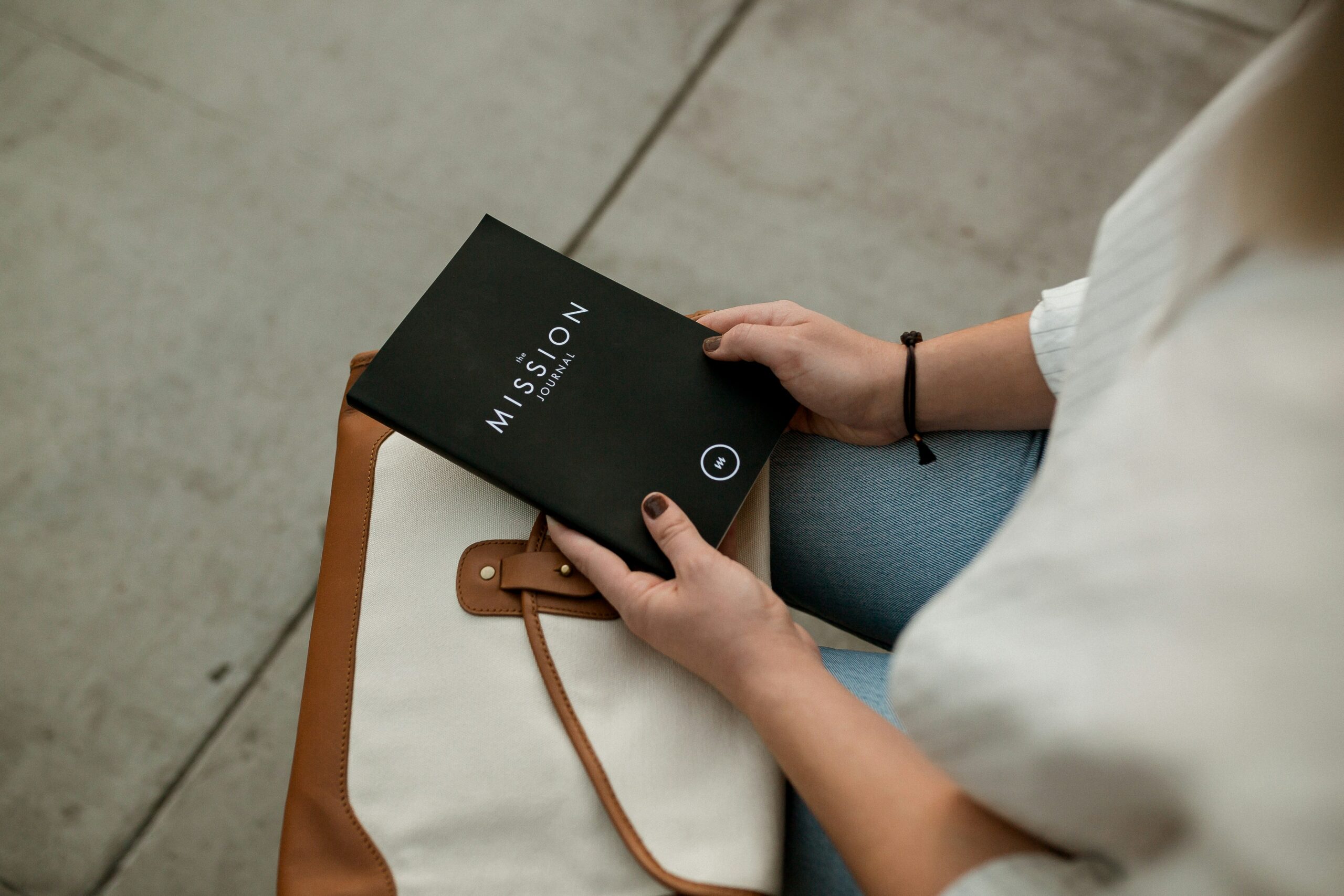 woman holding black Mission book